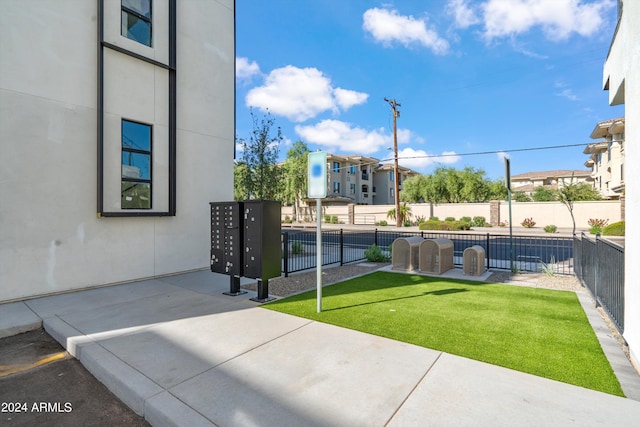 exterior space with a lawn and mail boxes