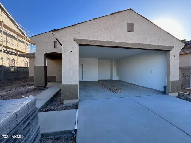 view of front of property with a carport and a garage