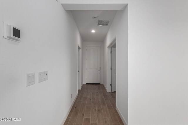 hallway with light hardwood / wood-style floors