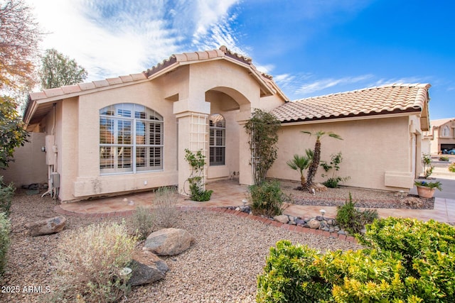 mediterranean / spanish-style house with a patio