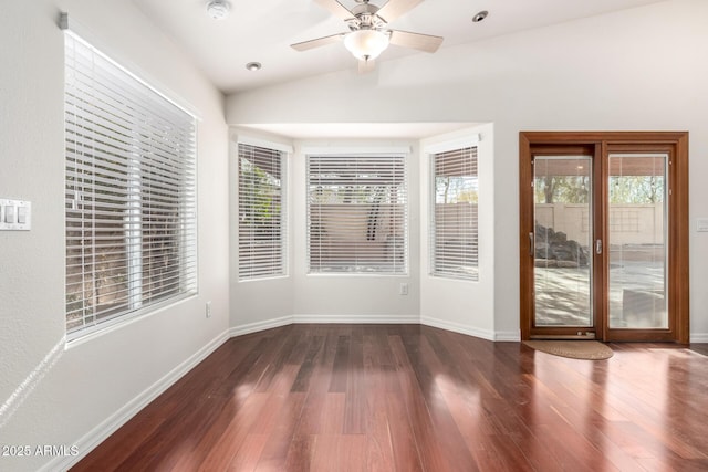 interior space with dark hardwood / wood-style flooring, a wealth of natural light, and lofted ceiling