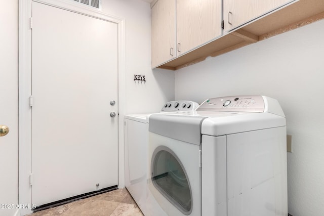 laundry area with cabinets and washer and dryer