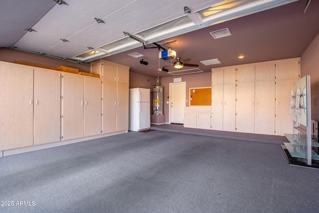 garage featuring a garage door opener, water heater, and white refrigerator