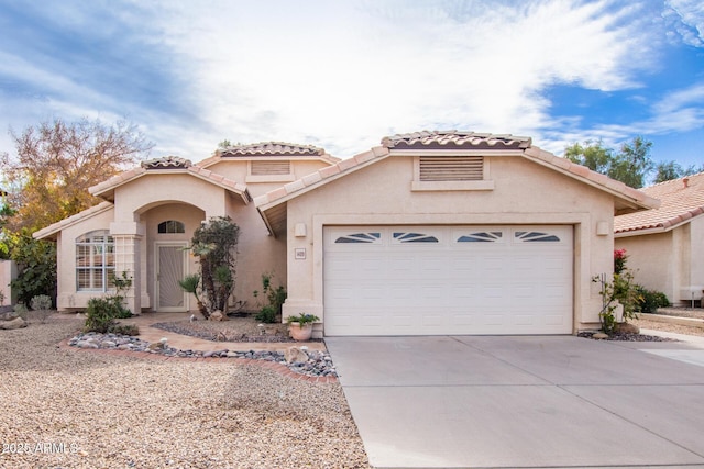 mediterranean / spanish-style house with a garage