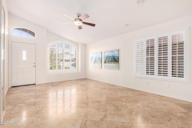 entryway with ceiling fan and lofted ceiling