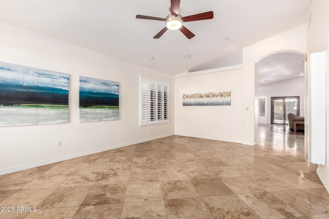 empty room featuring ceiling fan and vaulted ceiling