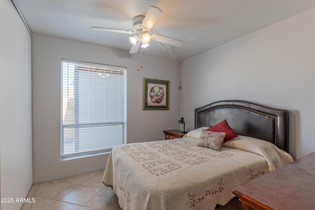 bedroom featuring multiple windows, light tile patterned floors, and ceiling fan
