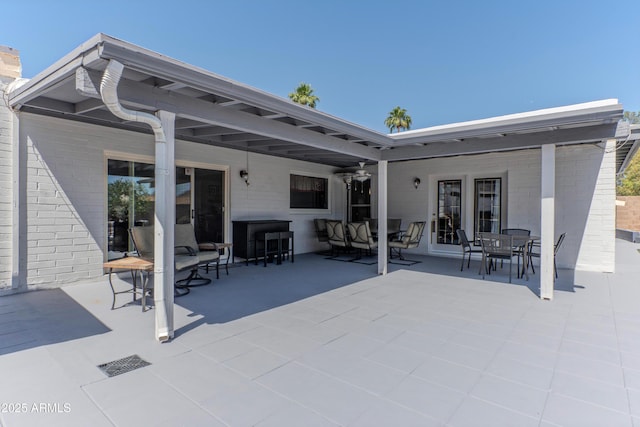 view of patio / terrace featuring outdoor dining area, french doors, and ceiling fan