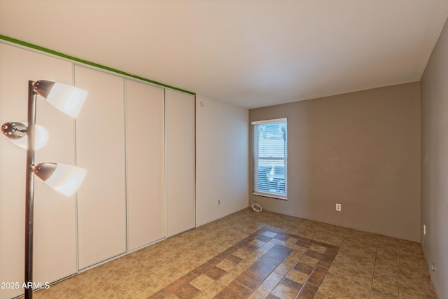 unfurnished bedroom featuring tile patterned flooring and a closet