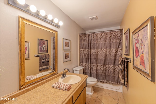 bathroom featuring toilet, tile patterned flooring, vanity, and shower / bath combo with shower curtain