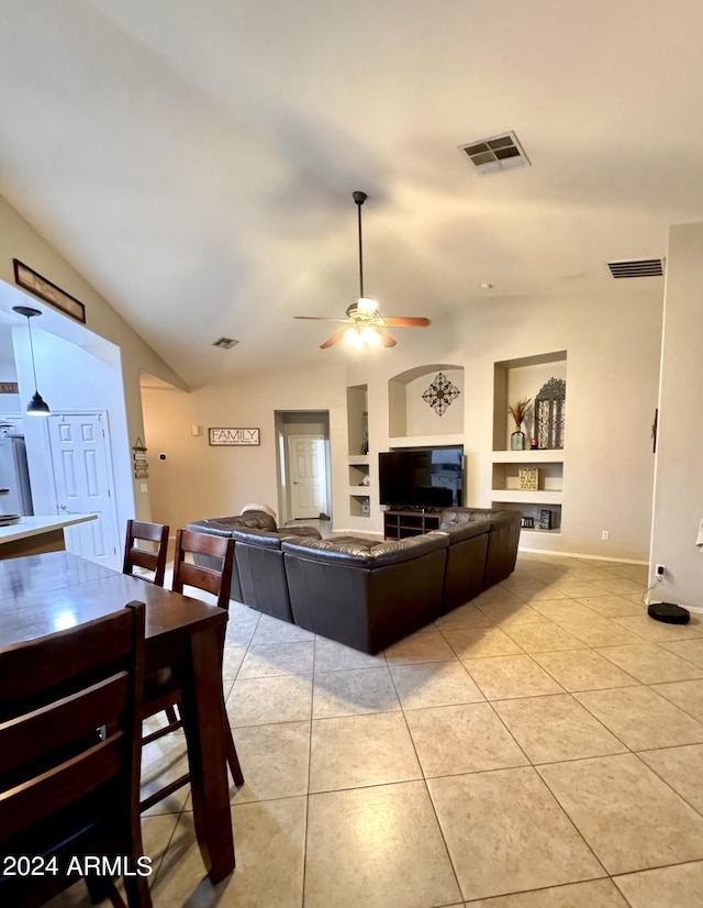 tiled living room featuring lofted ceiling, built in features, and ceiling fan