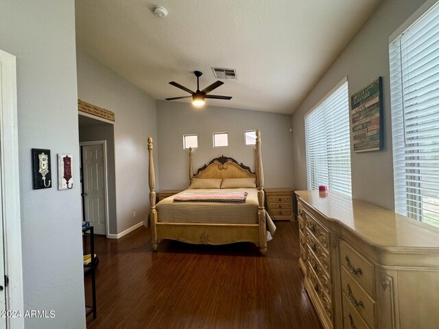 bedroom with lofted ceiling, wood finished floors, visible vents, and a ceiling fan