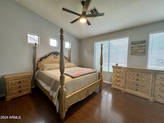 bedroom featuring multiple windows, vaulted ceiling, and wood finished floors