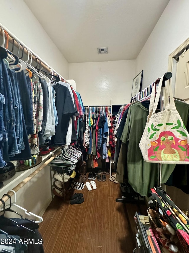 walk in closet with visible vents and wood finished floors