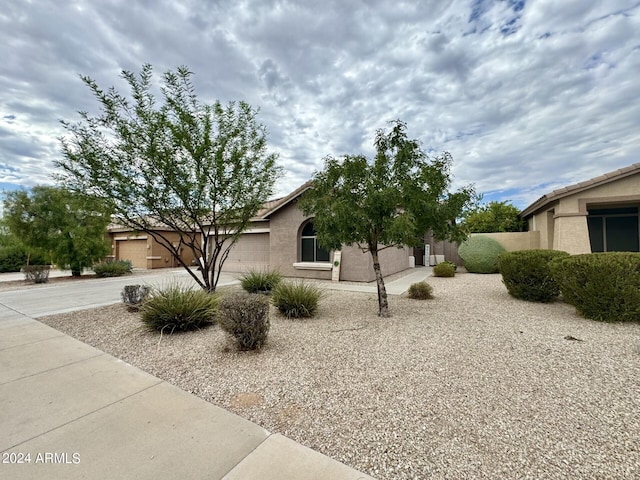 view of home's exterior with a garage, driveway, and stucco siding