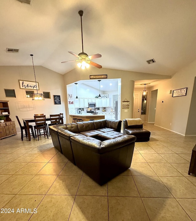 living area featuring ceiling fan, visible vents, vaulted ceiling, and light tile patterned flooring