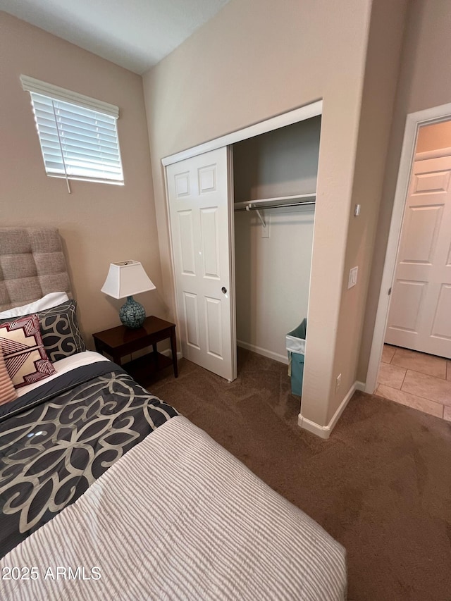 bedroom featuring a closet and dark carpet