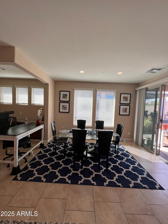 dining room featuring a healthy amount of sunlight and light tile patterned floors