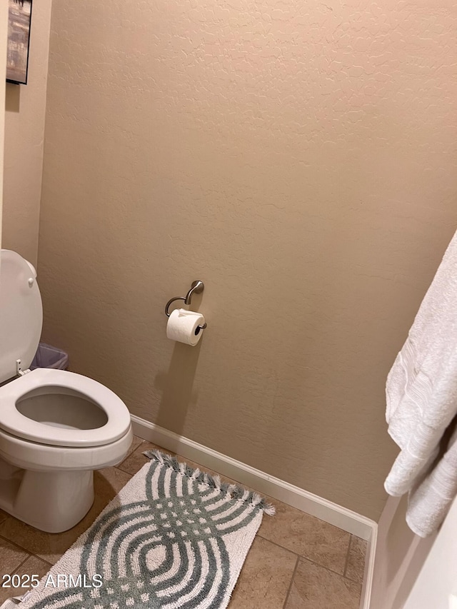 bathroom featuring toilet and tile patterned flooring