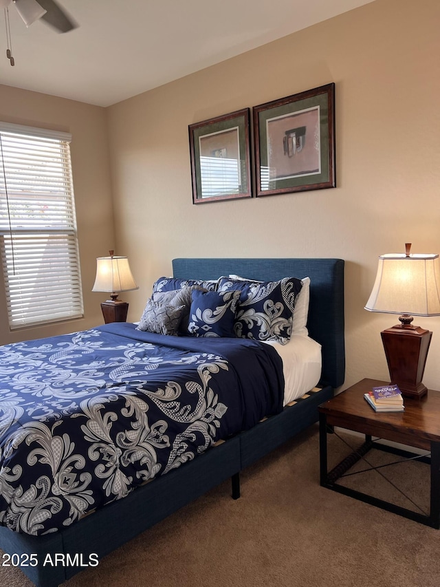 bedroom featuring ceiling fan and carpet floors