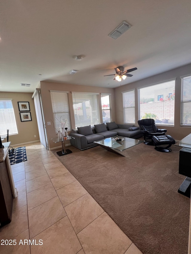 living room with ceiling fan and light tile patterned floors