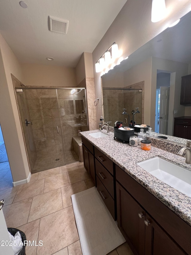 bathroom featuring an enclosed shower, vanity, and tile patterned floors