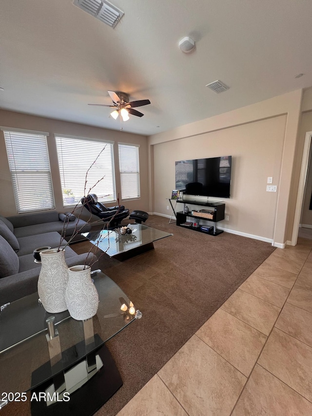 tiled living room with ceiling fan