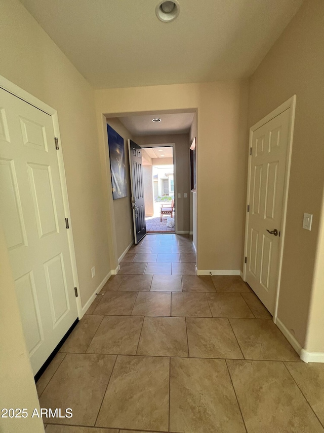 hall featuring light tile patterned flooring