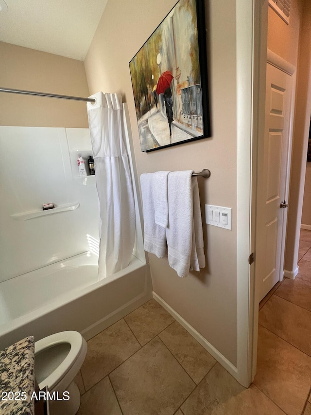 bathroom featuring tile patterned floors, shower / bath combo with shower curtain, and toilet