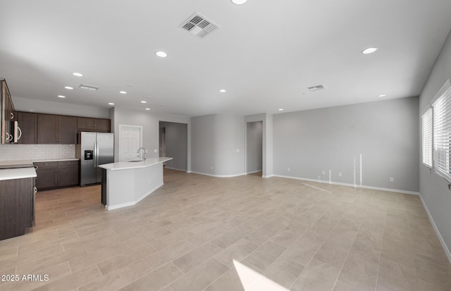 unfurnished living room featuring sink