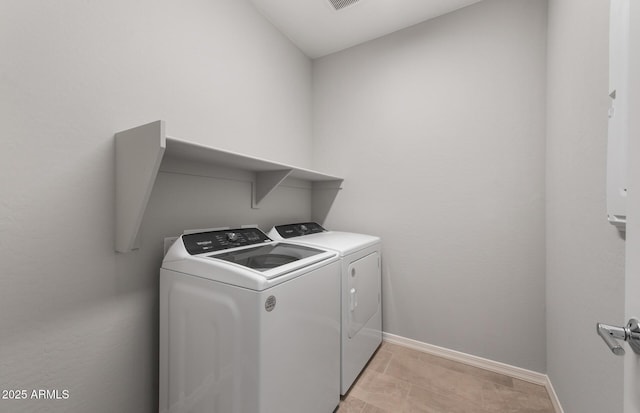 clothes washing area with washer and clothes dryer