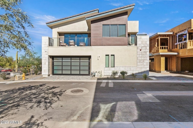 modern home featuring a balcony and a garage