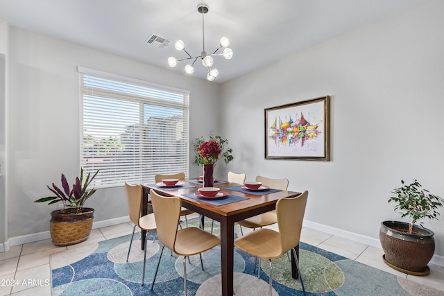 tiled dining space featuring an inviting chandelier