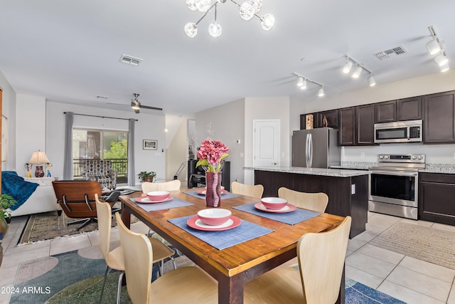 tiled dining room featuring ceiling fan