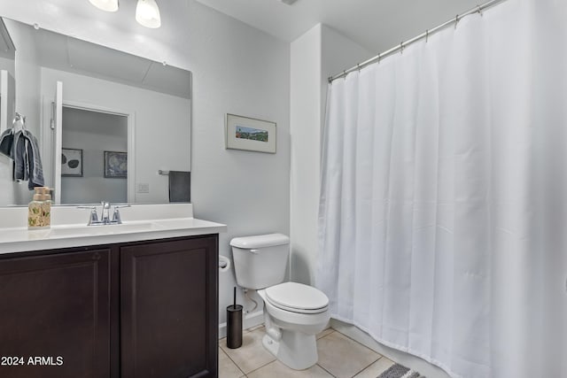 bathroom with vanity, toilet, and tile patterned floors