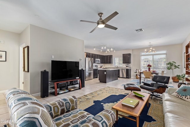 living room featuring light tile patterned floors and ceiling fan with notable chandelier