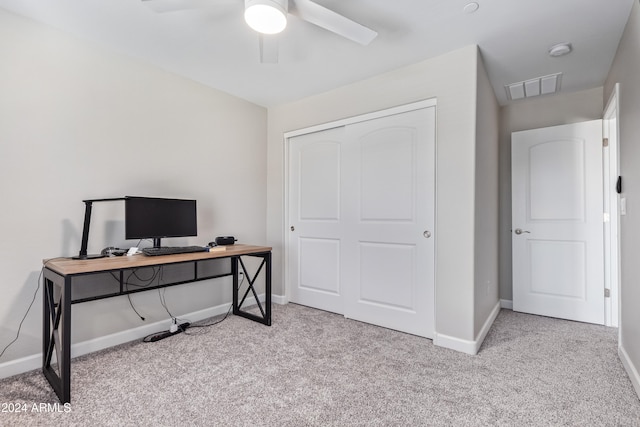 office space featuring light carpet and ceiling fan