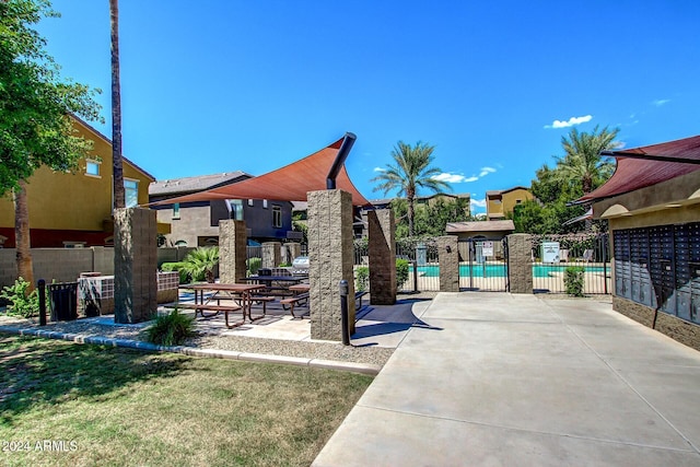 view of property's community featuring a swimming pool and a patio area