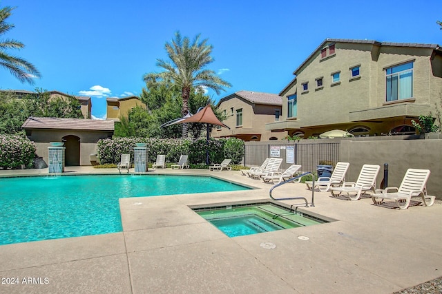 view of swimming pool featuring a patio area and a hot tub