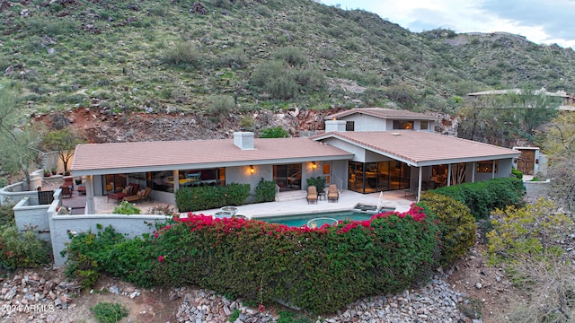 back of house with a patio area and a mountain view