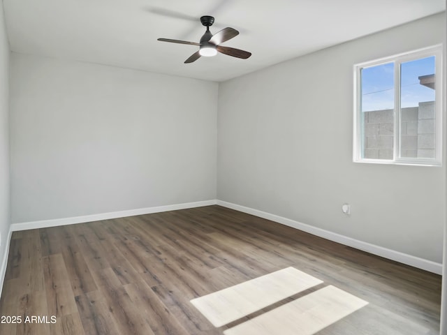 spare room featuring hardwood / wood-style flooring and ceiling fan