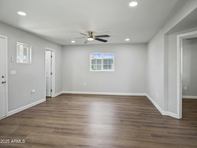 spare room featuring dark hardwood / wood-style floors and ceiling fan