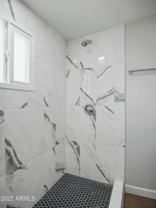 bathroom featuring a tile shower