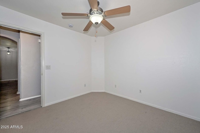 empty room featuring ceiling fan and carpet floors