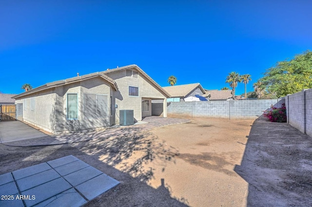 rear view of property featuring a patio and central air condition unit