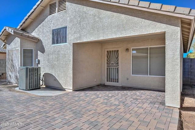 rear view of property featuring central AC and a patio