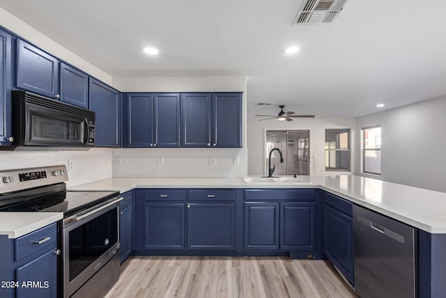 kitchen featuring sink, kitchen peninsula, blue cabinets, light hardwood / wood-style floors, and stainless steel appliances