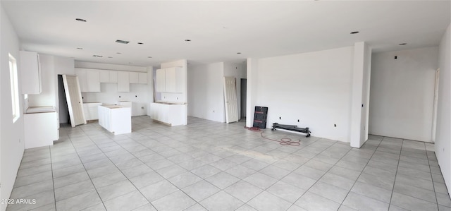 unfurnished living room with light tile flooring