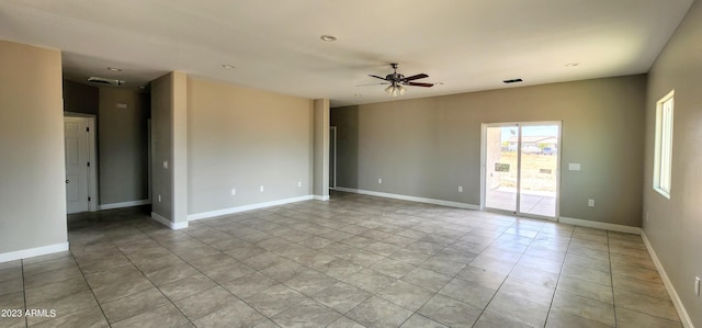 spare room with ceiling fan and light tile flooring