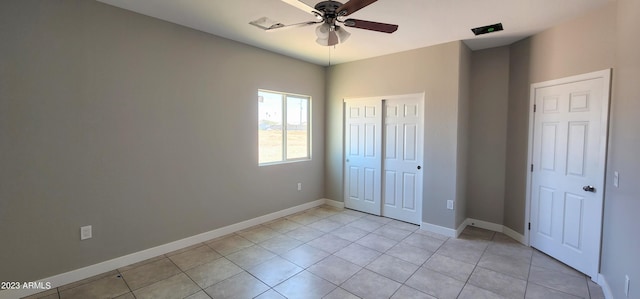 unfurnished bedroom with light tile flooring and ceiling fan